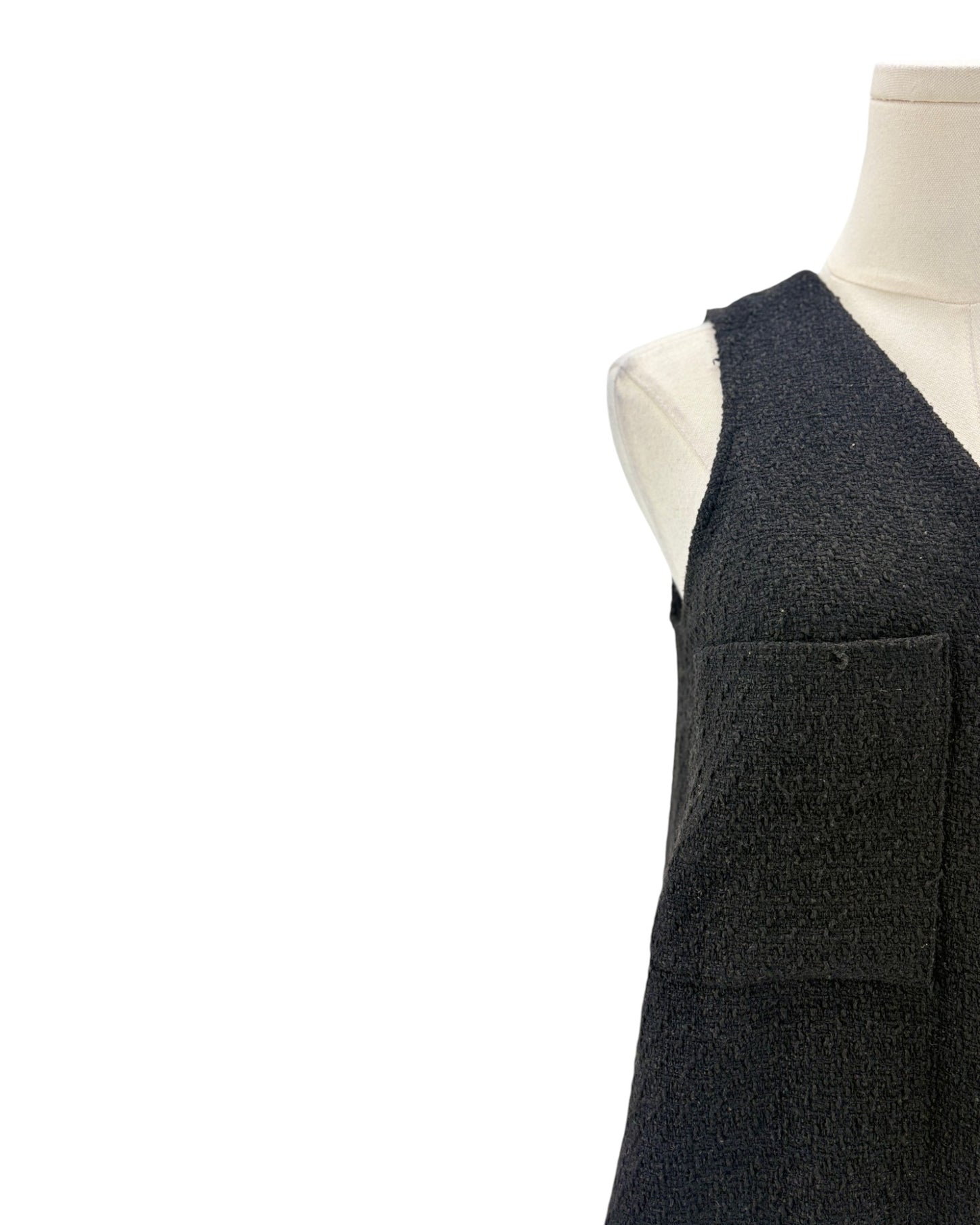 Black textured material on a mannequin against a white background