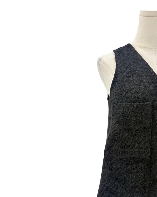 Black textured material on a mannequin against a white background