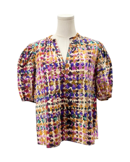 Multicolored floral blouse on a mannequin against a white background