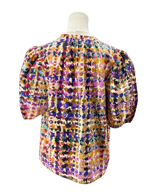 Multicolored floral blouse on a mannequin against a white background