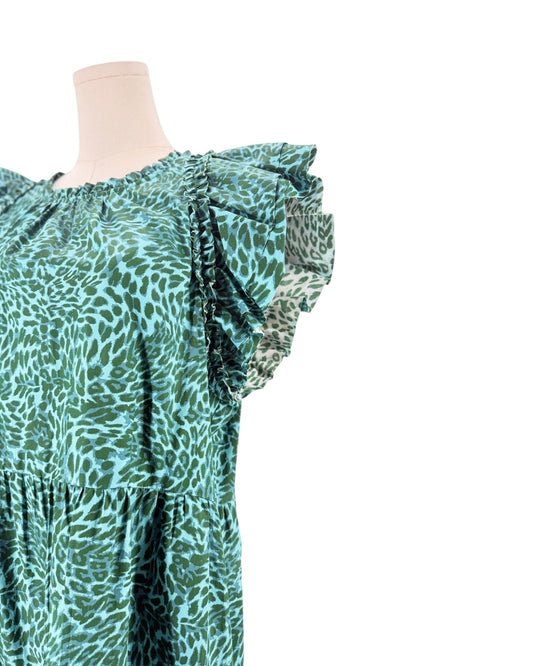 A close-up of a green and teal animal print dress on a mannequin torso, featuring ruffled cap sleeves and a tiered waist, set against a plain white background.