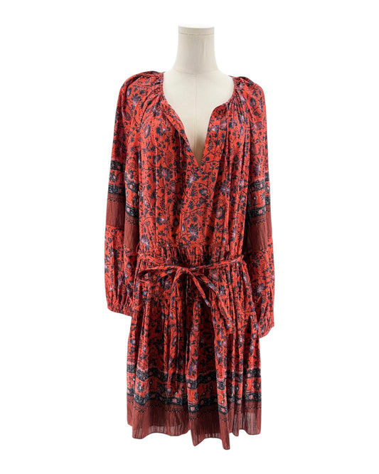 Red patterned dress on a mannequin against a white background