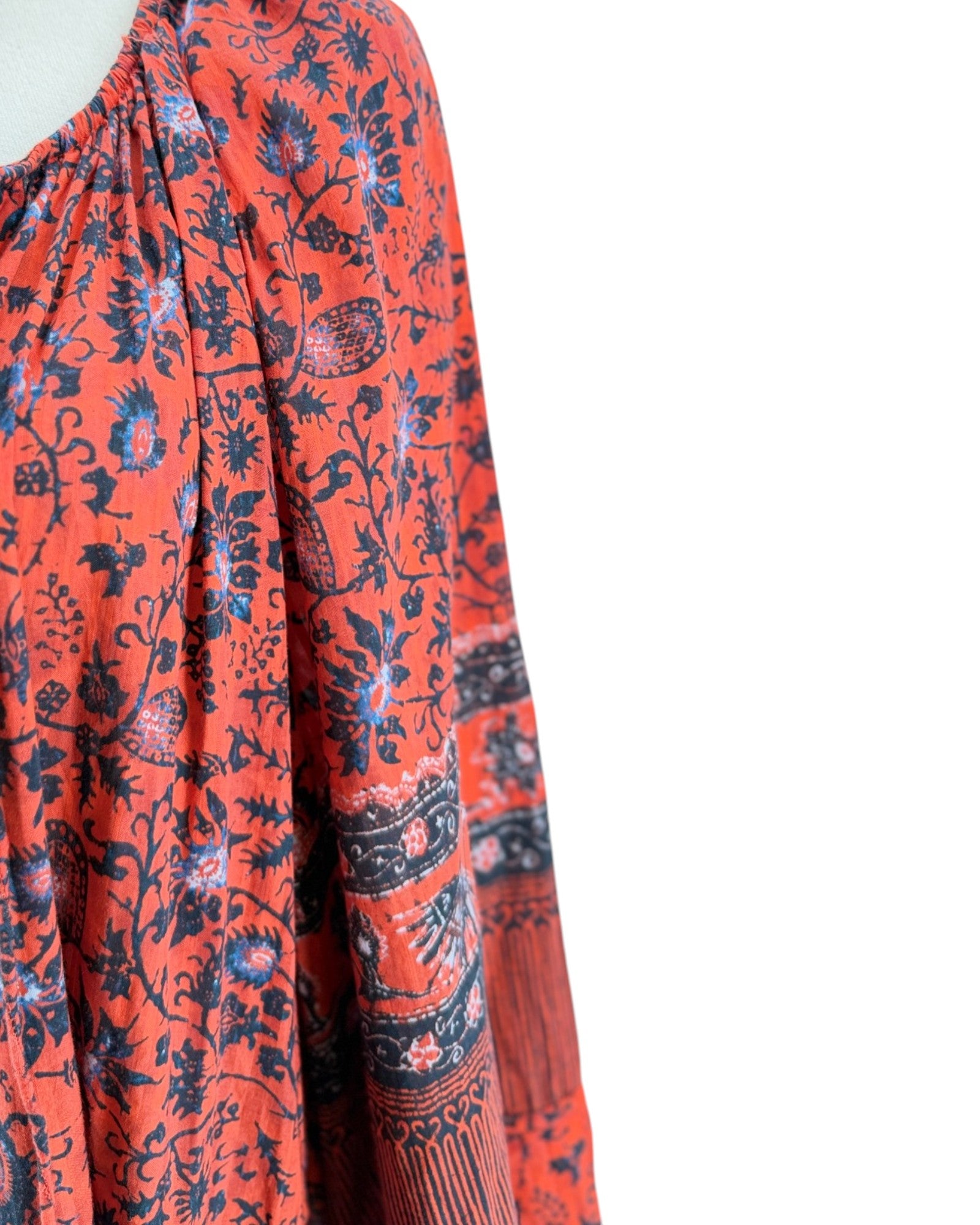 Red floral patterned dress with long sleeves on a white background