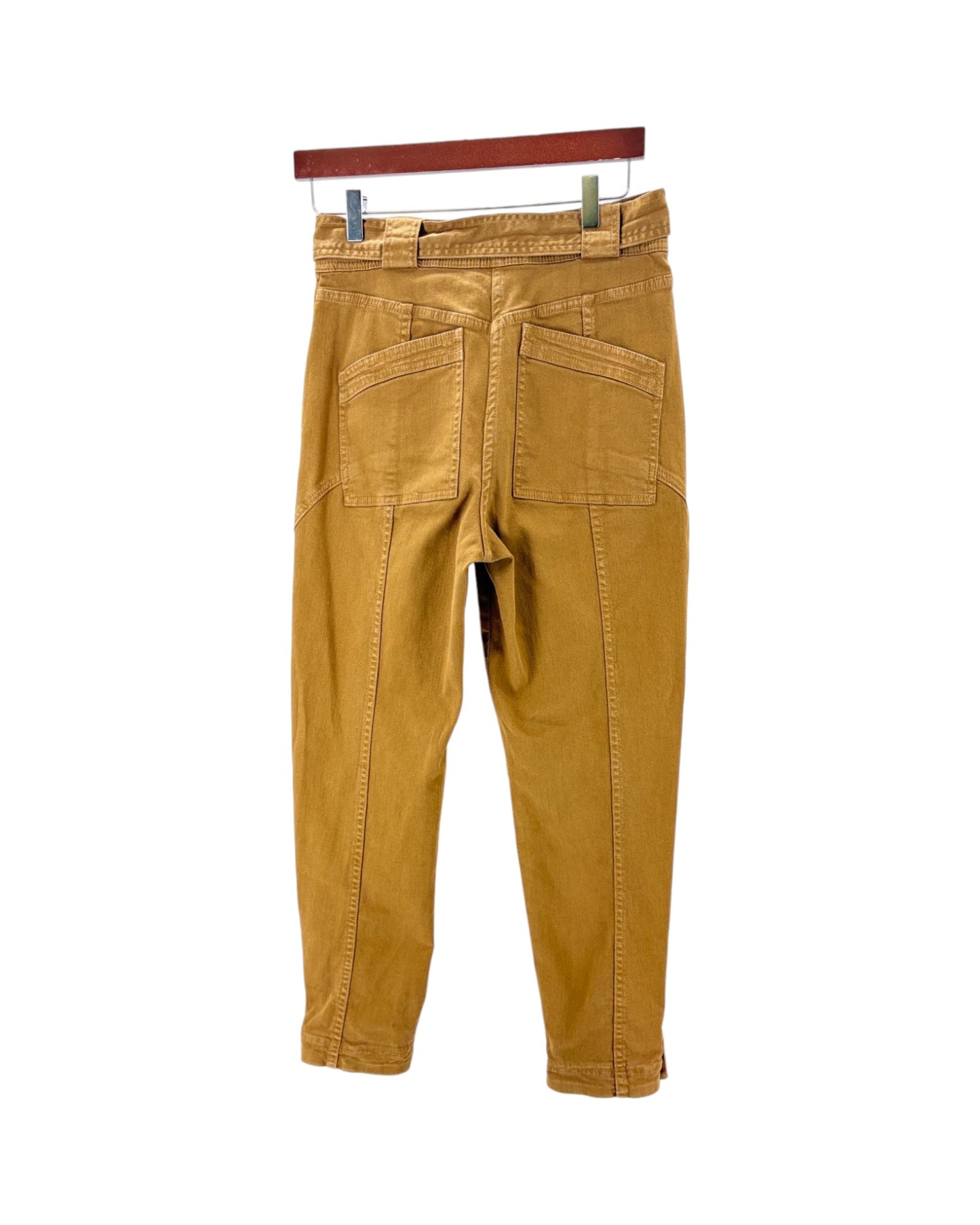 A pair of mustard yellow corduroy pants shown from the back, hanging from a wooden hanger against a plain white background.