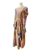Multicolored patterned dress on a mannequin against a white background