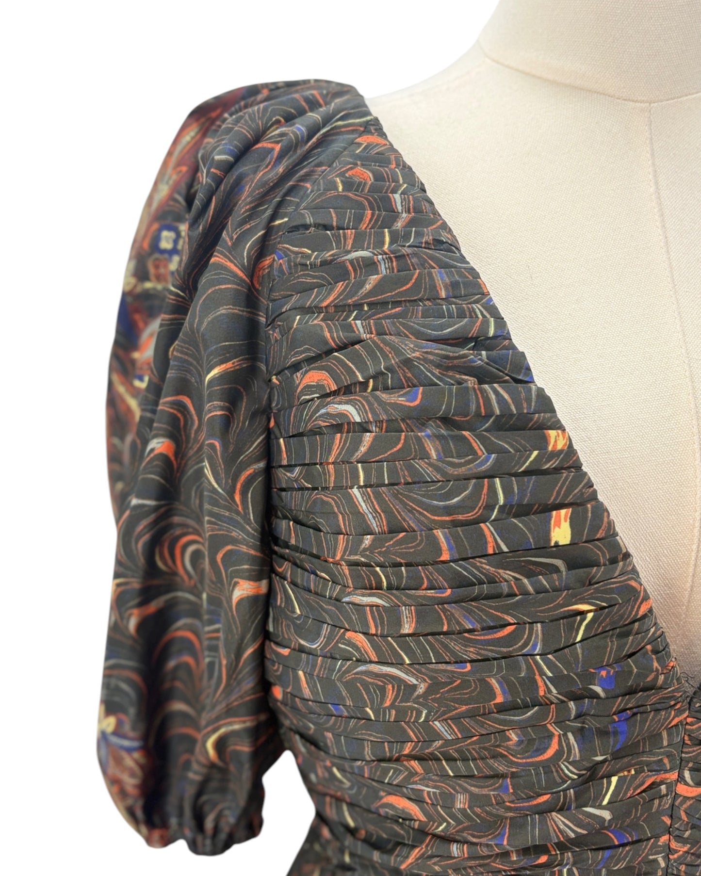 Patterned fabric dress on a mannequin on a white background