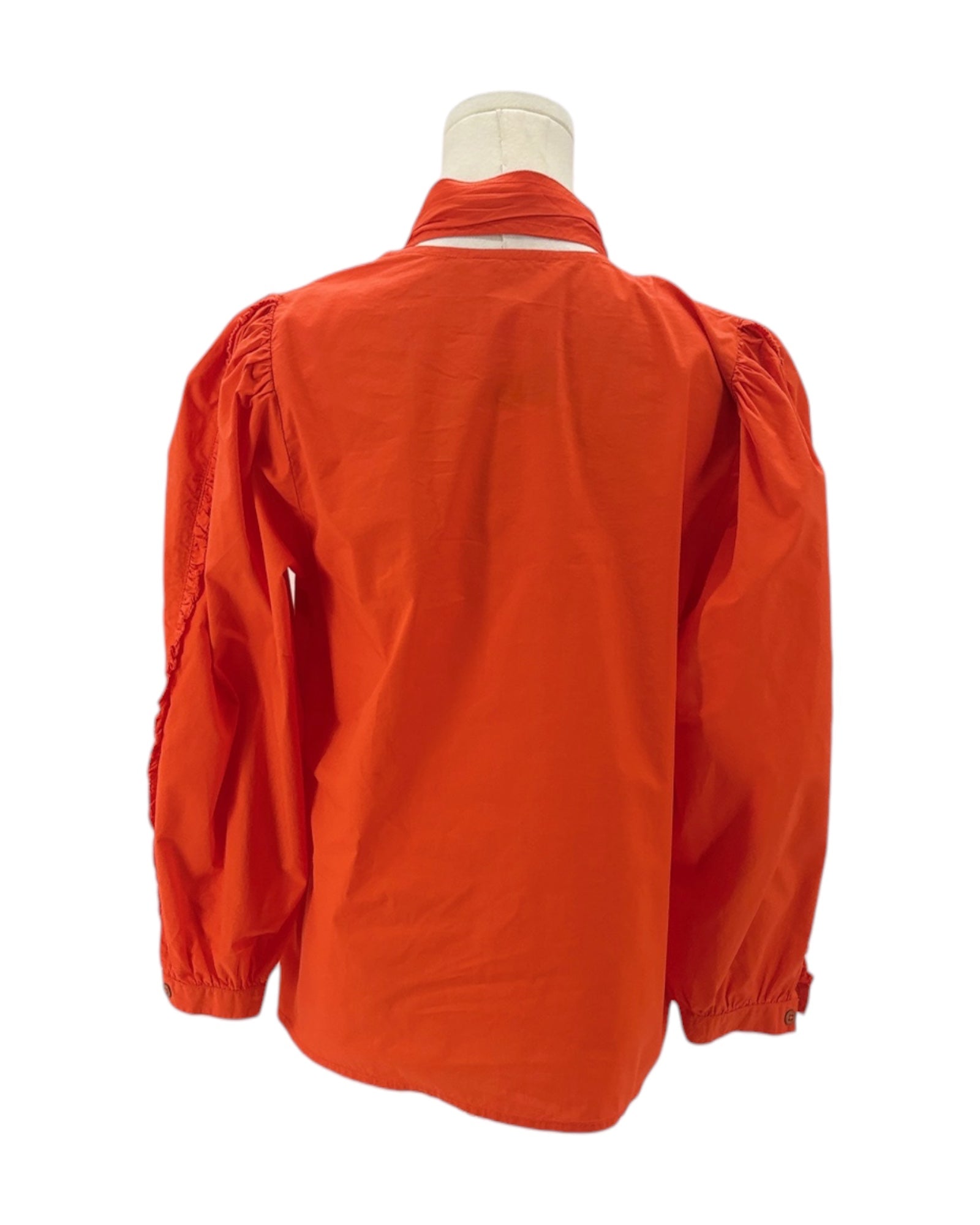 Orange jacket on a mannequin against a white background