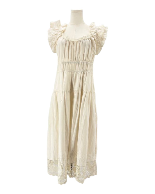 Ulla Johnson cream dress with ruffled sleeves on a mannequin against a white background