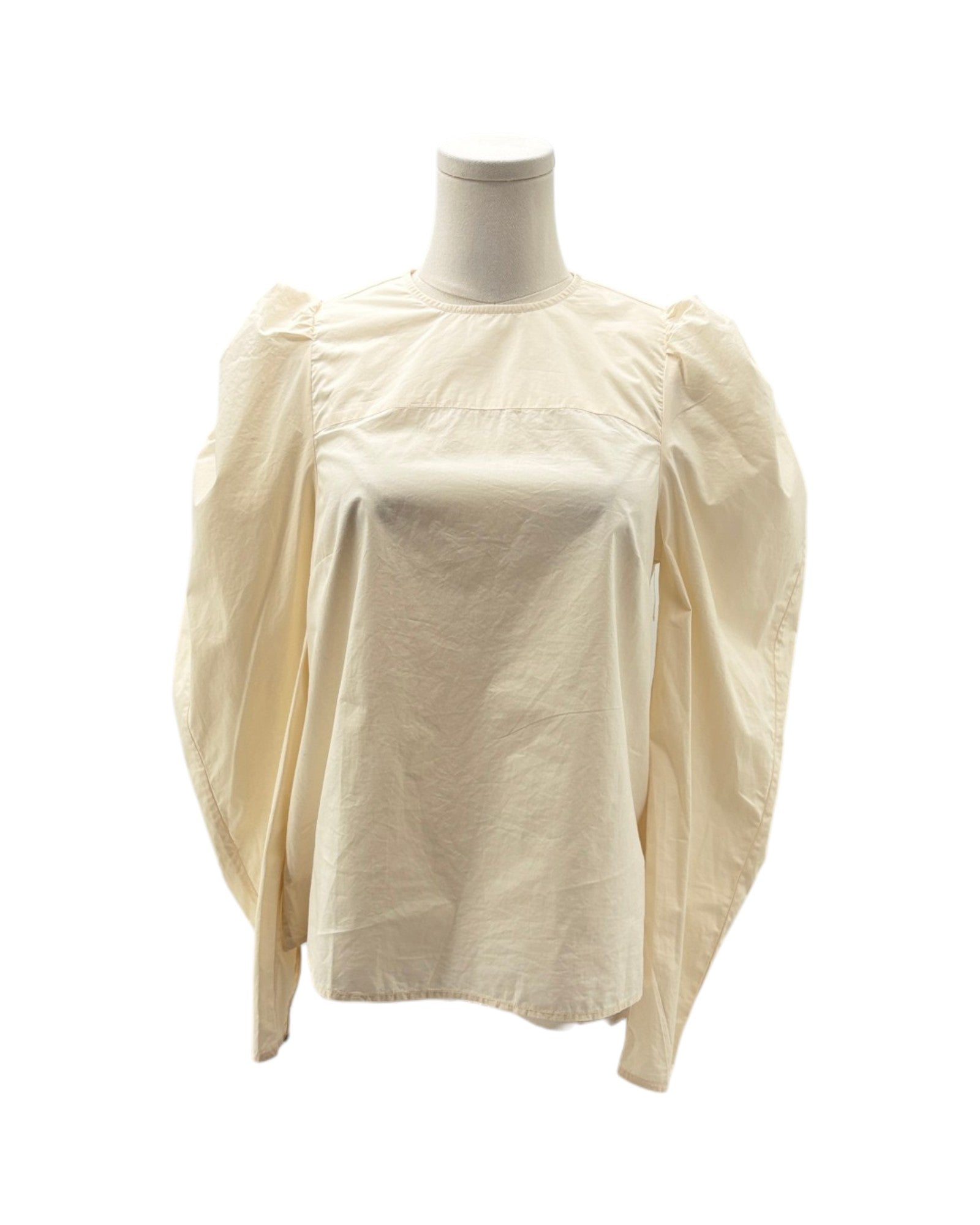 Beige blouse on a mannequin against a white background