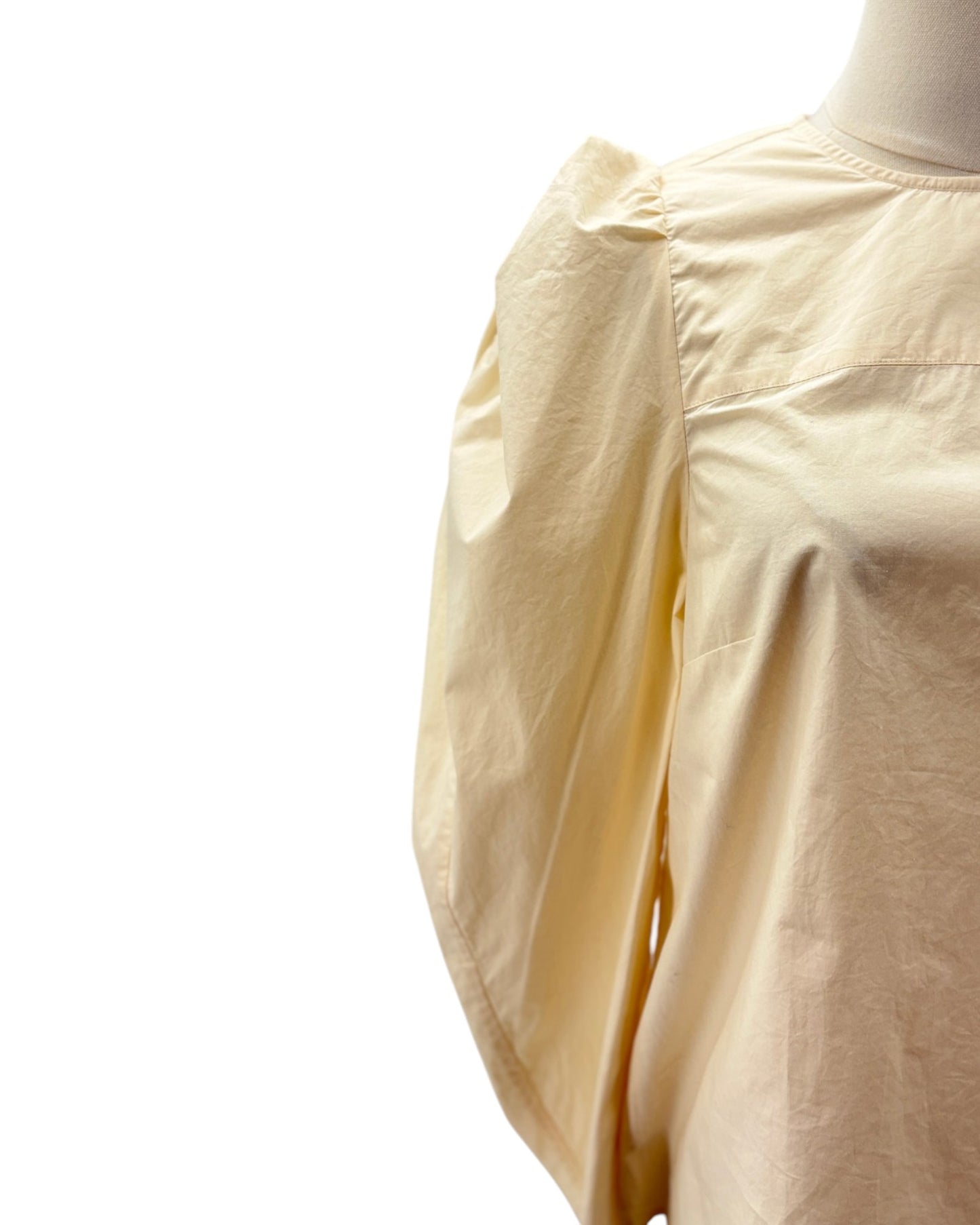 Beige shirt on a mannequin with a white background