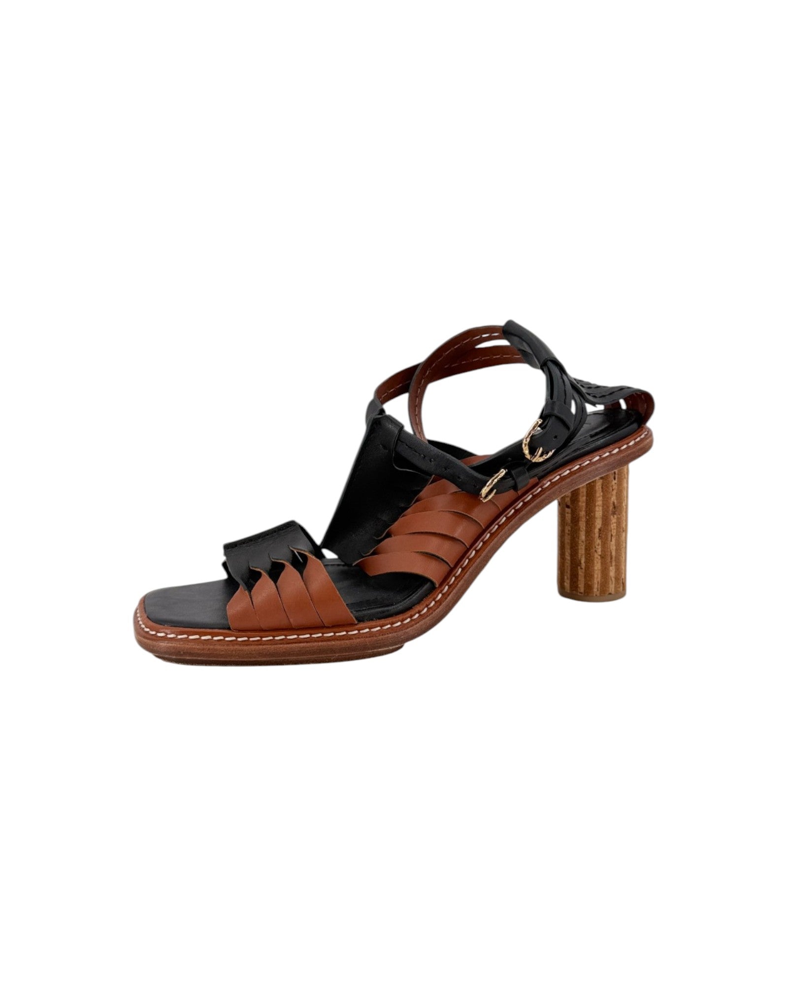 A women's strappy sandal with a chunky block heel, featuring brown leather cutout straps, black straps and footbed, and a textured brown wooden-look heel on a white background.