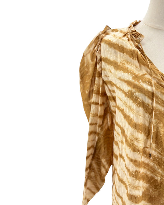 Mannequin wearing a gold and white striped blouse on a white background