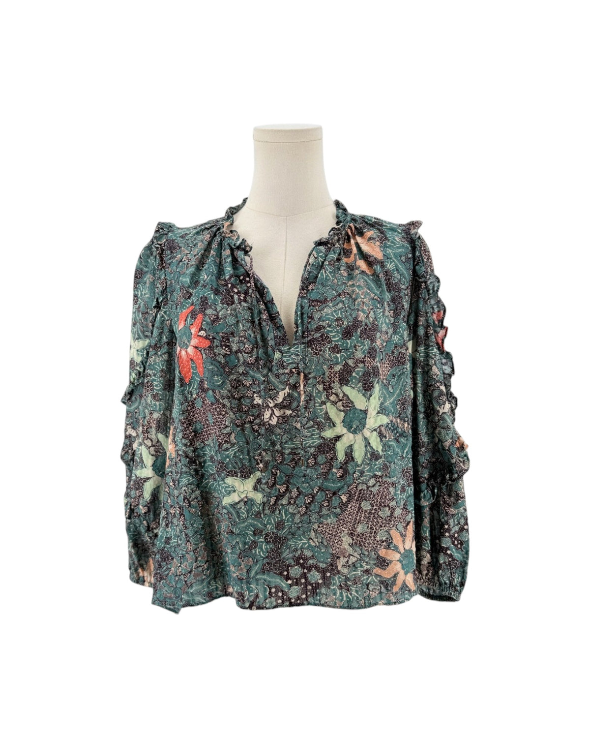 Multi color geometric floral print, full length sleeves with cascade sleeves finished with elastic cuff, v-neckline with tassel detail on a mannequin on a white background