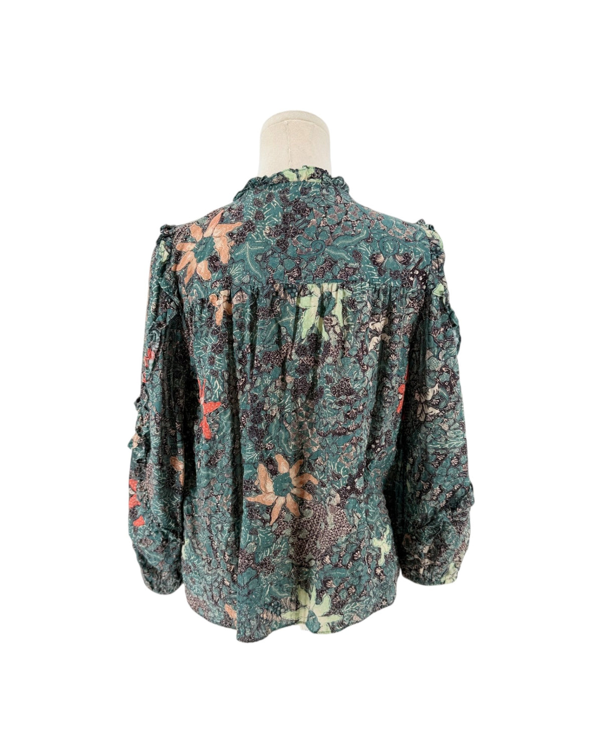 Multi color geometric floral print, full length sleeves with cascade sleeves finished with elastic cuff, v-neckline with tassel detail on a mannequin on a white background