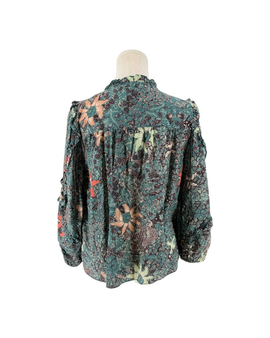 Multi color geometric floral print, full length sleeves with cascade sleeves finished with elastic cuff, v-neckline with tassel detail on a mannequin on a white background
