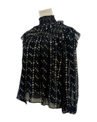 Ulla Johnson black blouse with gold pattern on a mannequin against a white background