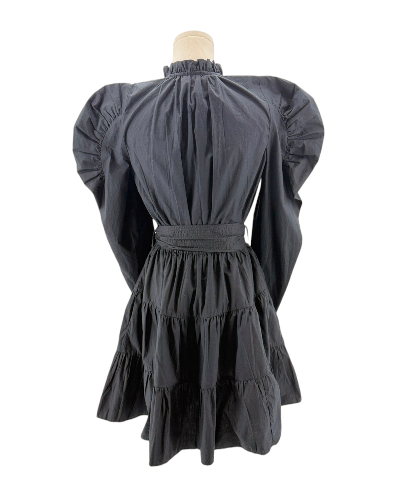 Black dress with puffed sleeves on a mannequin against a white background