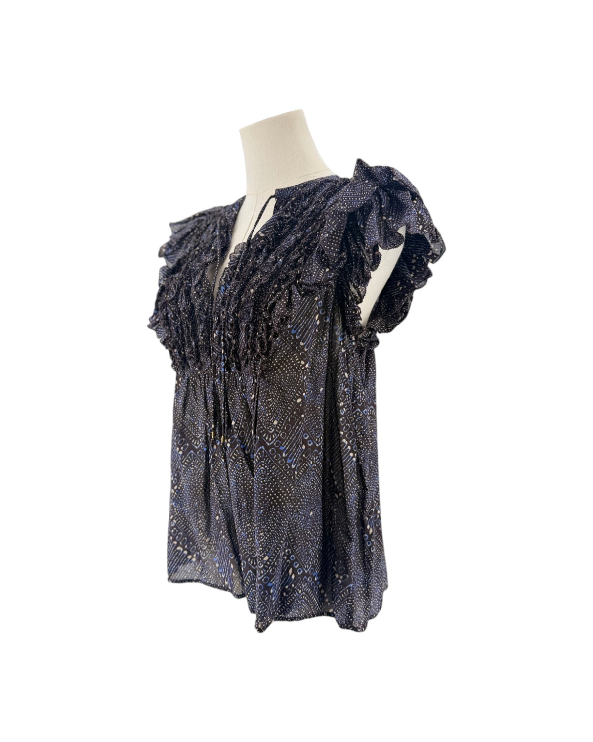 Short sleeve mulberry diamond print, tiered ruffle sleeves, smocked detailing along the split v-neckline, drawstring tassel accent on a mannequin on a white background
