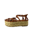 Brown sandal with woven platform sole on a white background