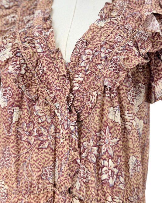 Multi color Floral print, midi length, double flutter sleeves, smocked neckline with delicate ruffles, buttoned placket, elastic waistband with drawstring ties dress on a mannequin on a white background