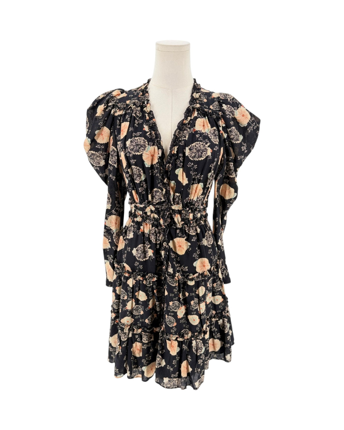 A black long-sleeve mini dress with a beige and peach floral pattern, displayed on a cream mannequin torso against a plain white background.