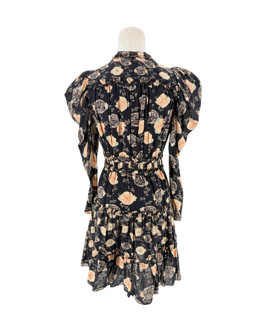 A black long-sleeve mini dress with a beige and peach floral pattern, displayed on a cream mannequin torso against a plain white background.