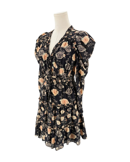 A black long-sleeve mini dress with a beige and peach floral pattern, displayed on a cream mannequin torso against a plain white background.