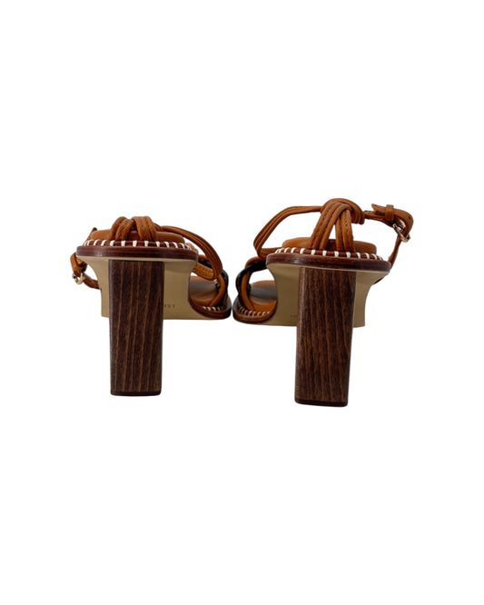 Pair of brown high-heeled sandals on a white background