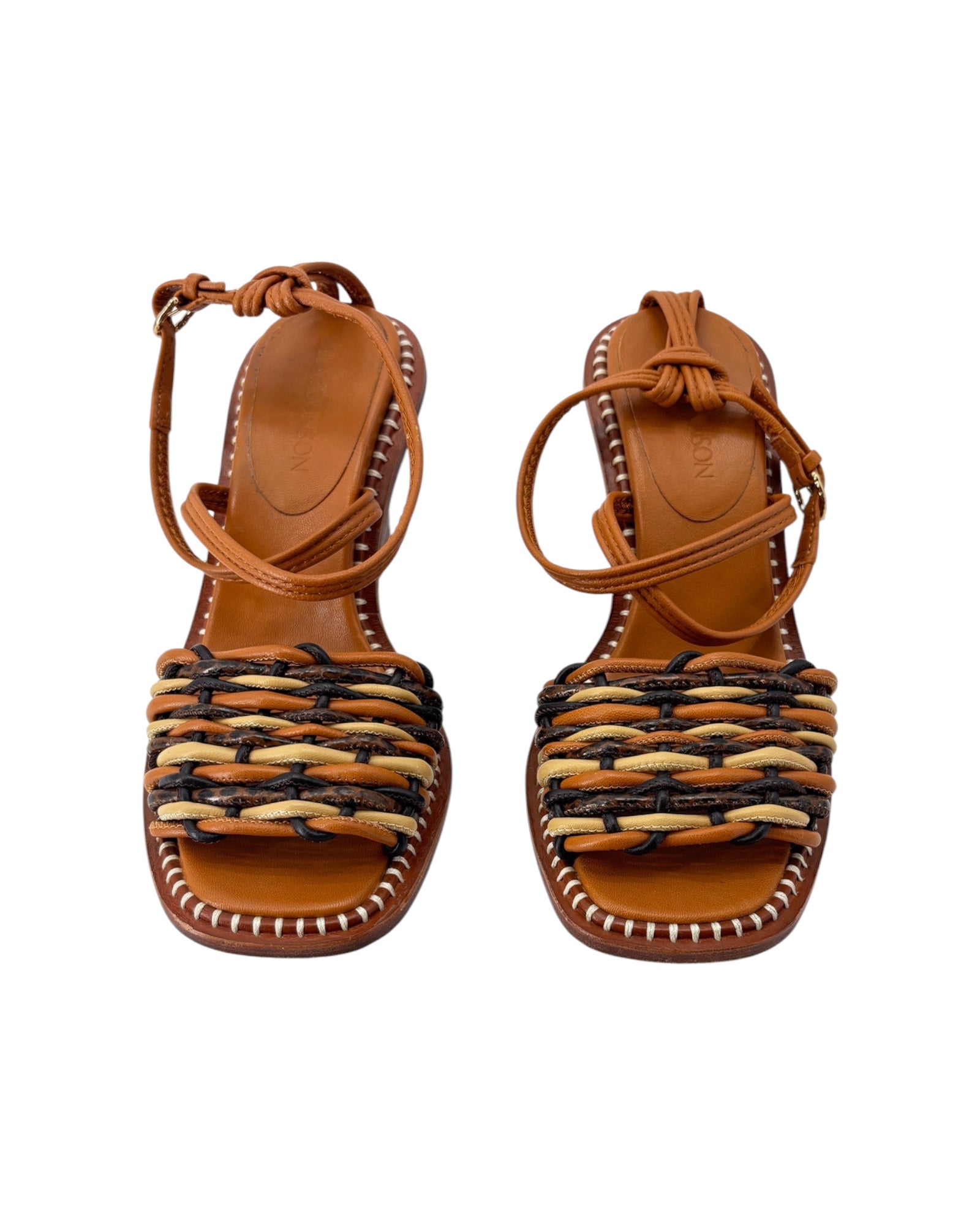 Pair of brown sandals with woven design on a white background