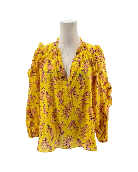 Yellow floral blouse on a mannequin against a white background