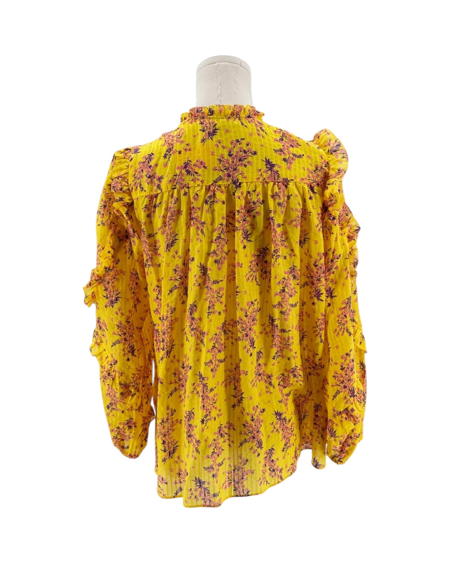 Yellow floral blouse on a mannequin against a white background