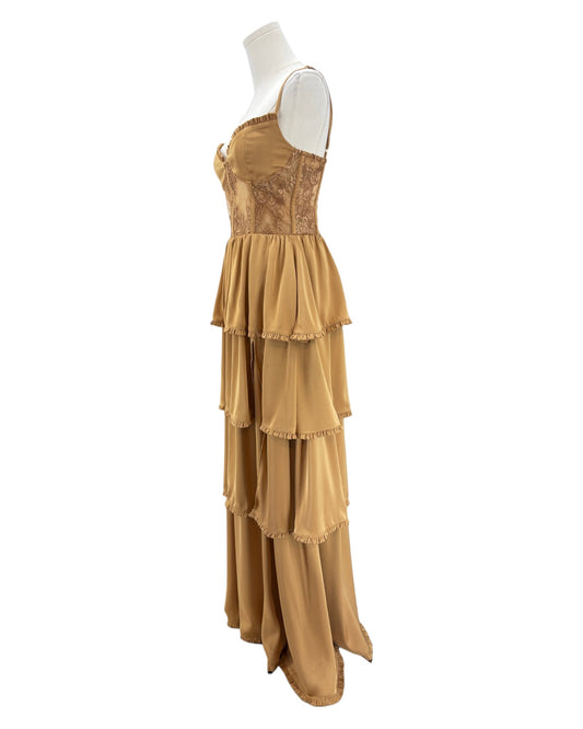 Gold evening gown on a mannequin against a white background