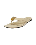 Cream sandal with gold accent on white background
