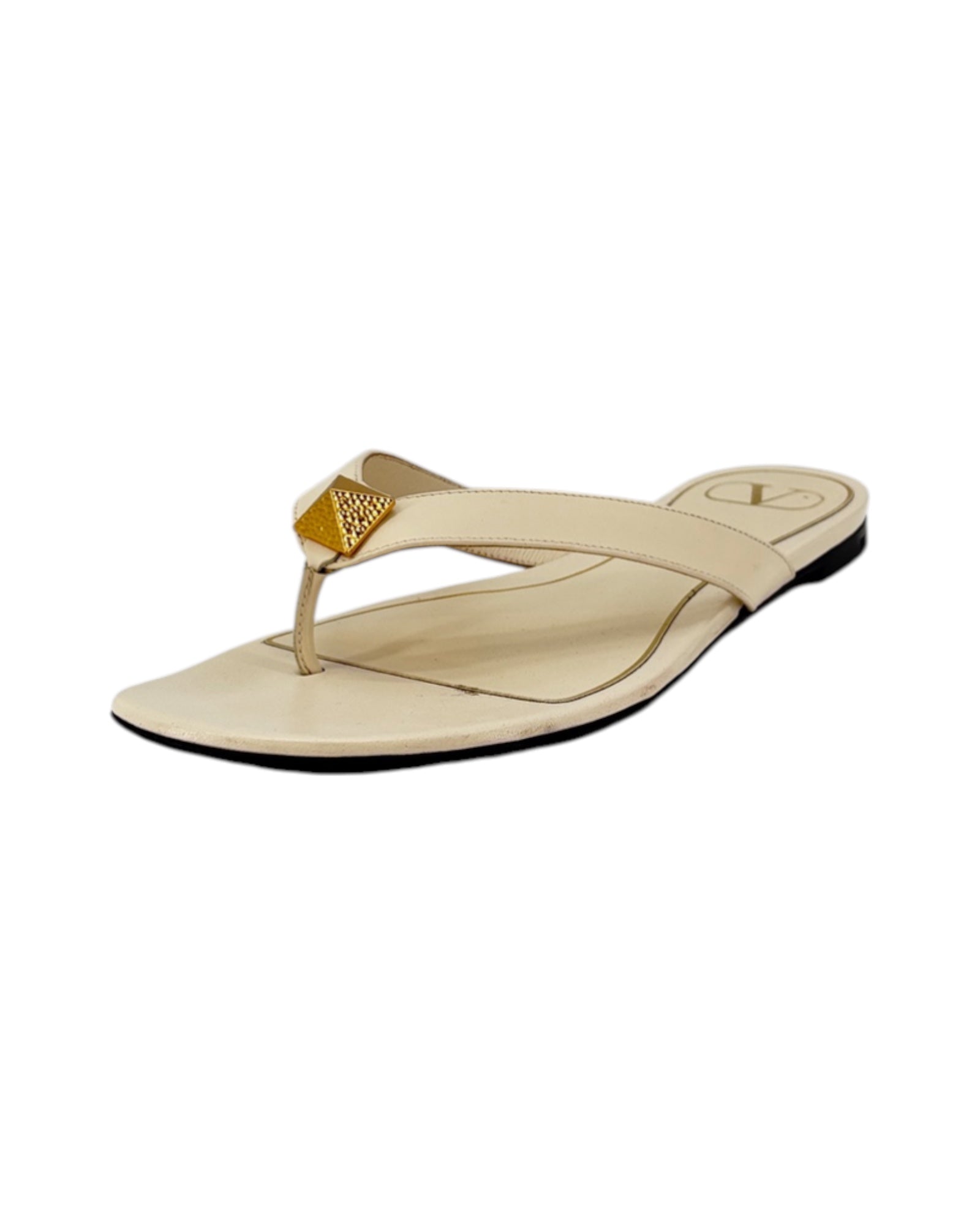 Cream sandal with gold accent on white background