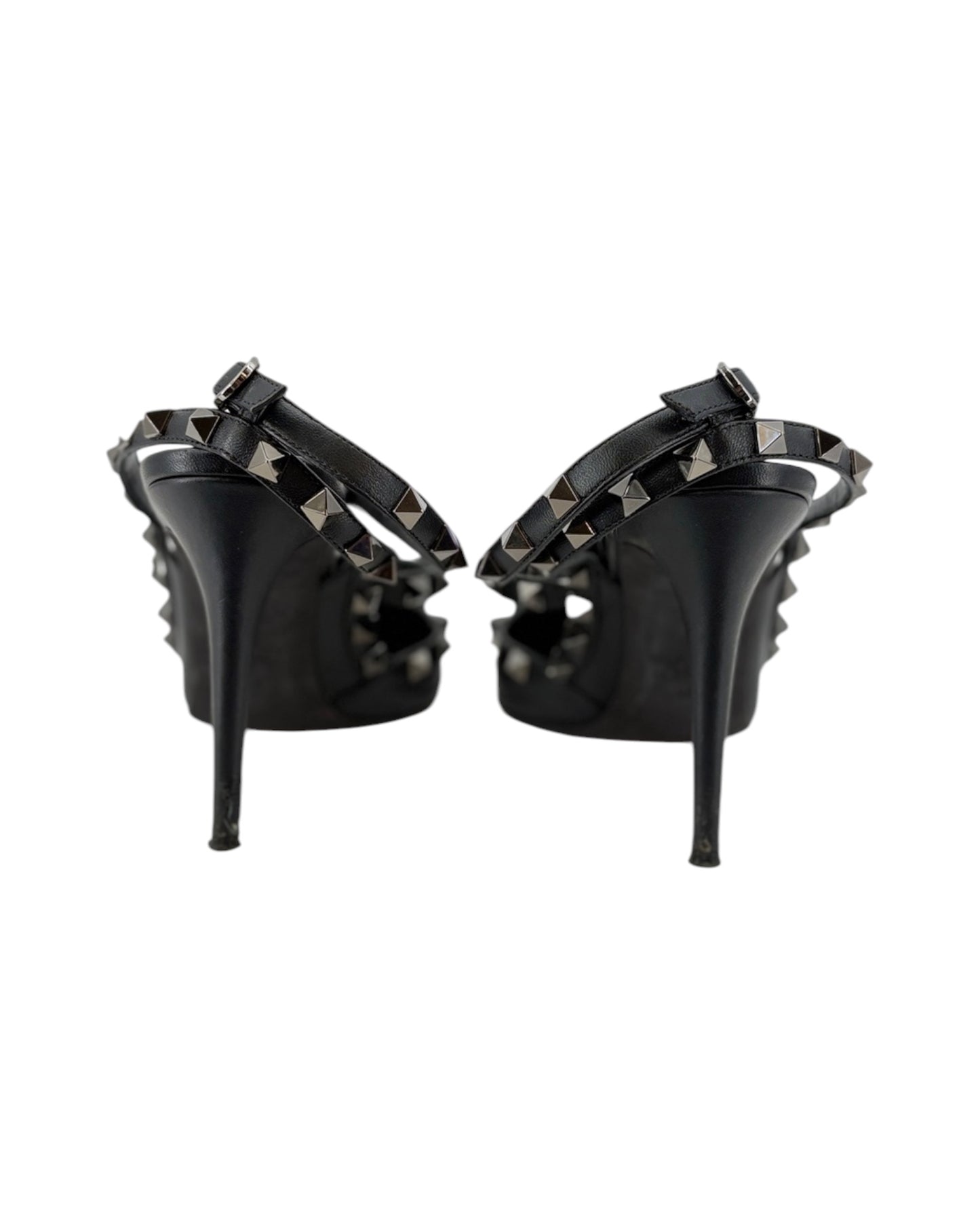 Black high-heeled shoes with studded details on a white background