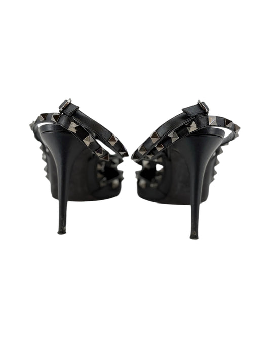 Black high-heeled shoes with studded details on a white background