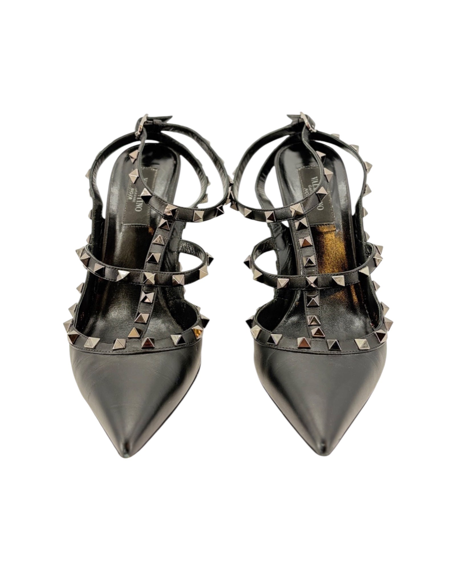 Pair of black studded high-heeled shoes on a white background