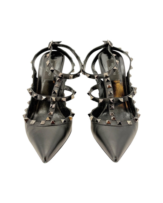 Pair of black studded high-heeled shoes on a white background