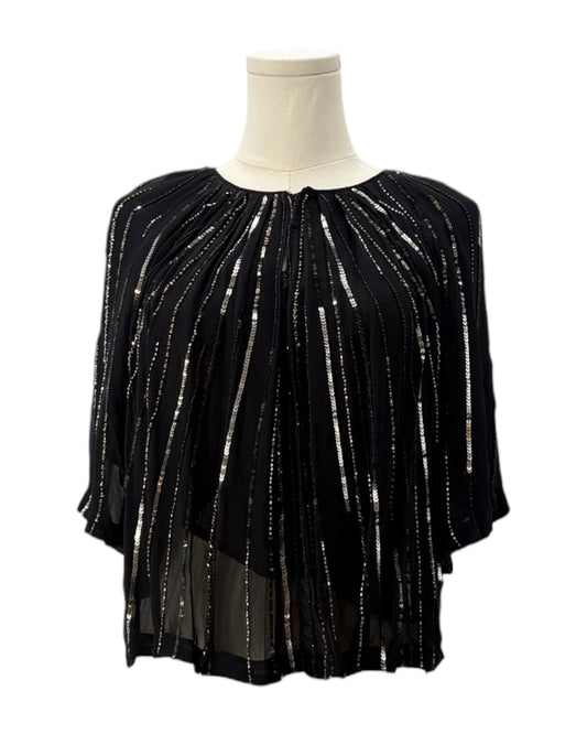 Black sequin top on a mannequin against a white background