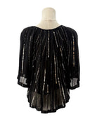 Black beaded blouse on a mannequin with a white background