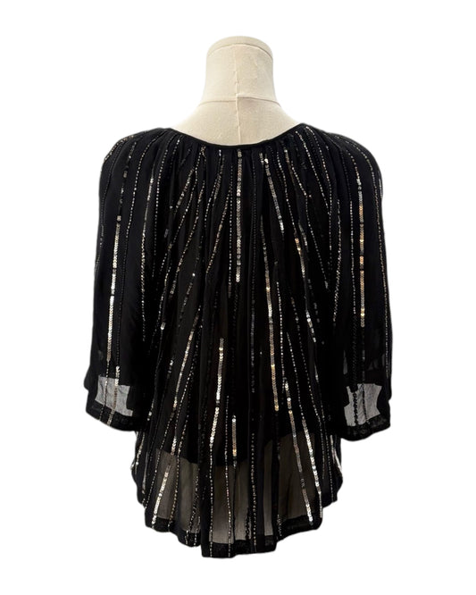 Black beaded blouse on a mannequin with a white background