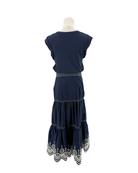 Navy sleeveless midi dress with delicate trim along the hem, scoop neck, side zip and hook. On a mannequin on a white background.