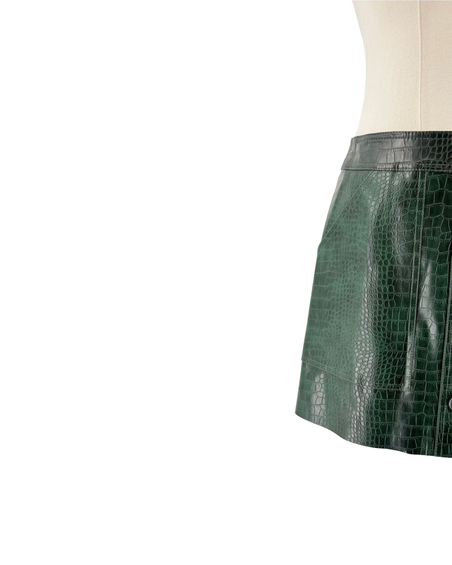 Green crocodile-patterned skirt on a mannequin against a white background