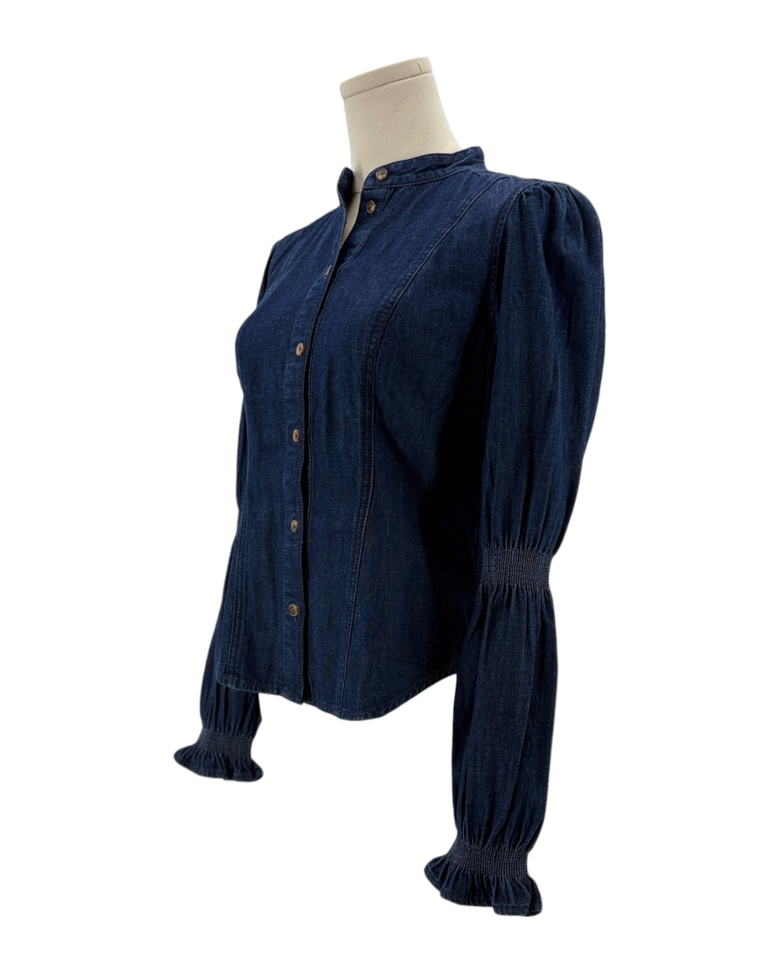 Navy blue blouse on a mannequin against a white background