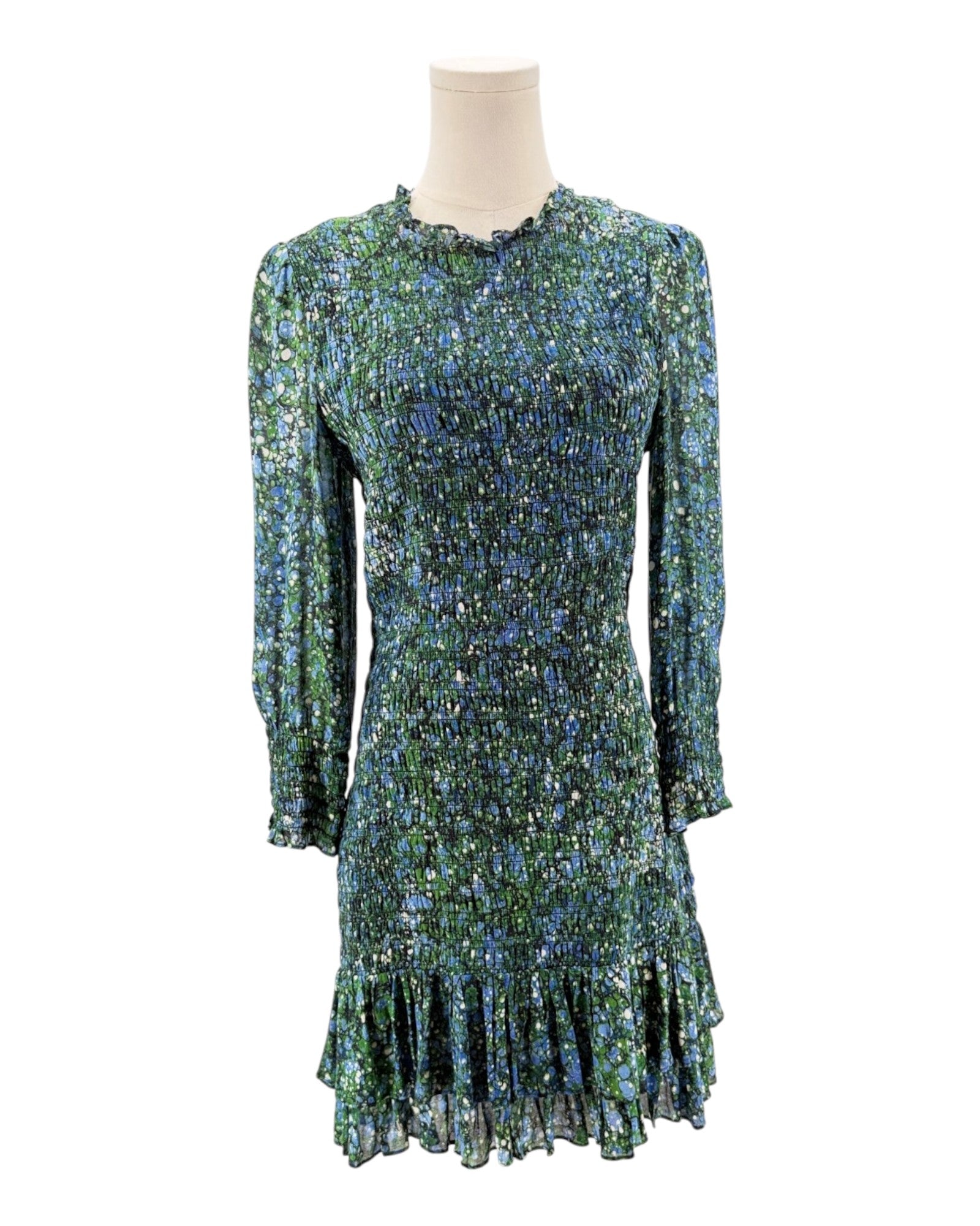 Green and blue patterned dress on a mannequin against a white background