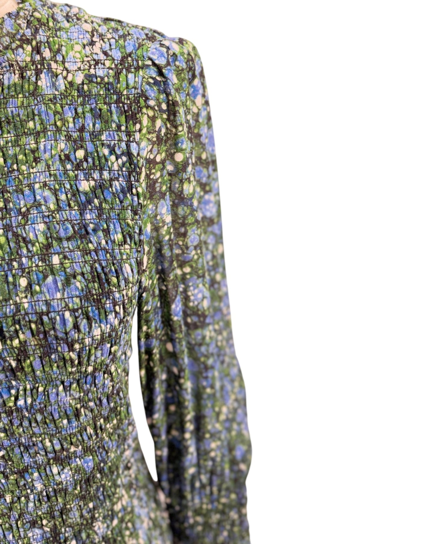 Close-up of a floral-patterned dress with long sleeves on a white background
