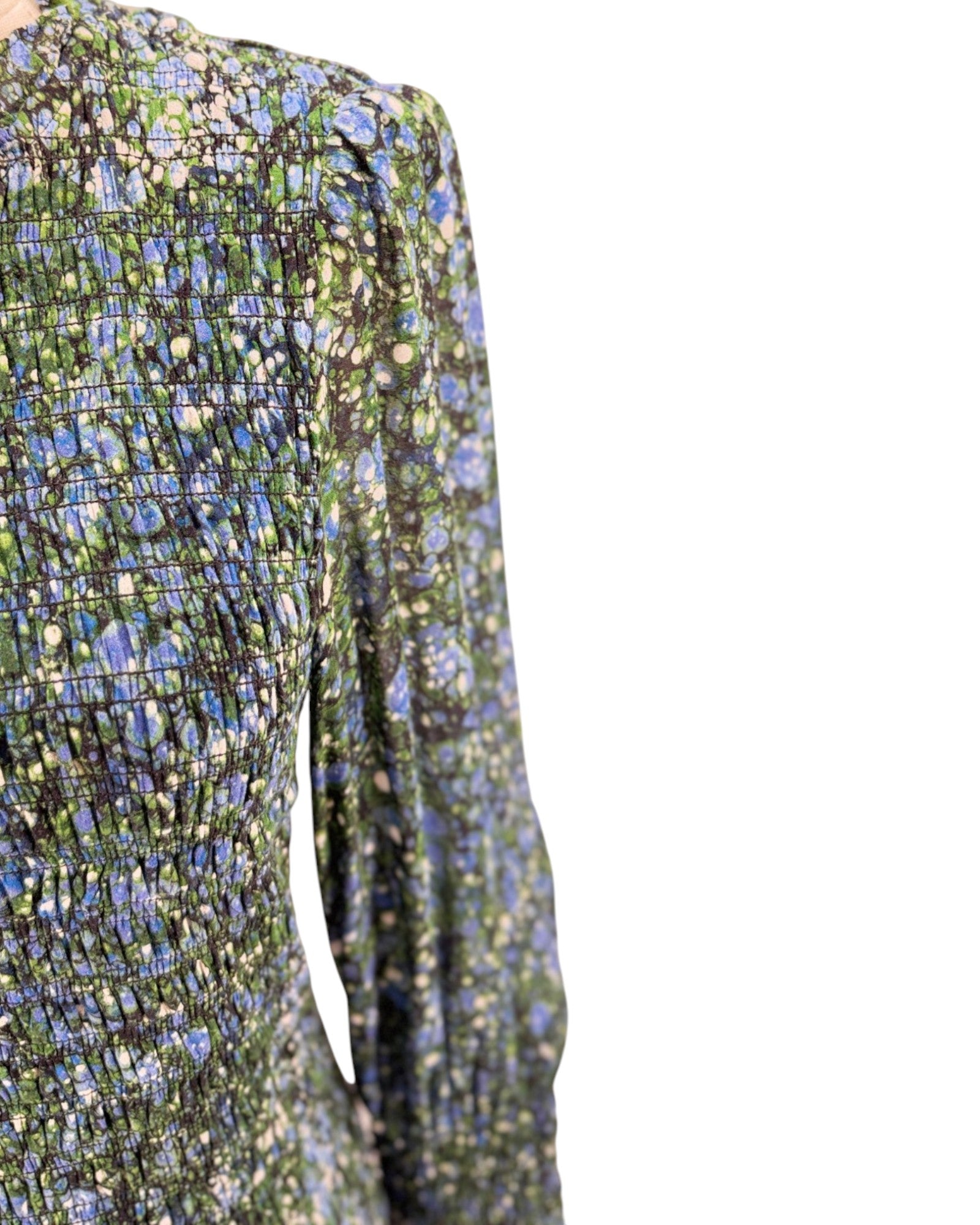 Close-up of a floral-patterned dress with long sleeves on a white background