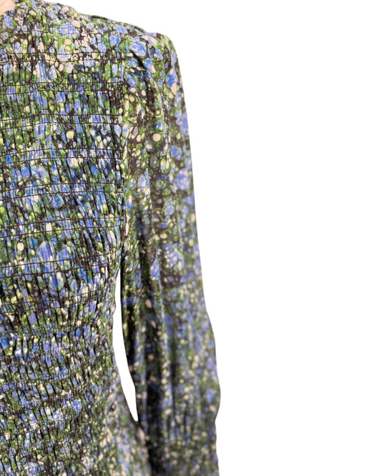 Close-up of a floral-patterned dress with long sleeves on a white background