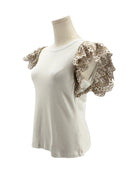 White top with lace sleeves on a mannequin against a white background