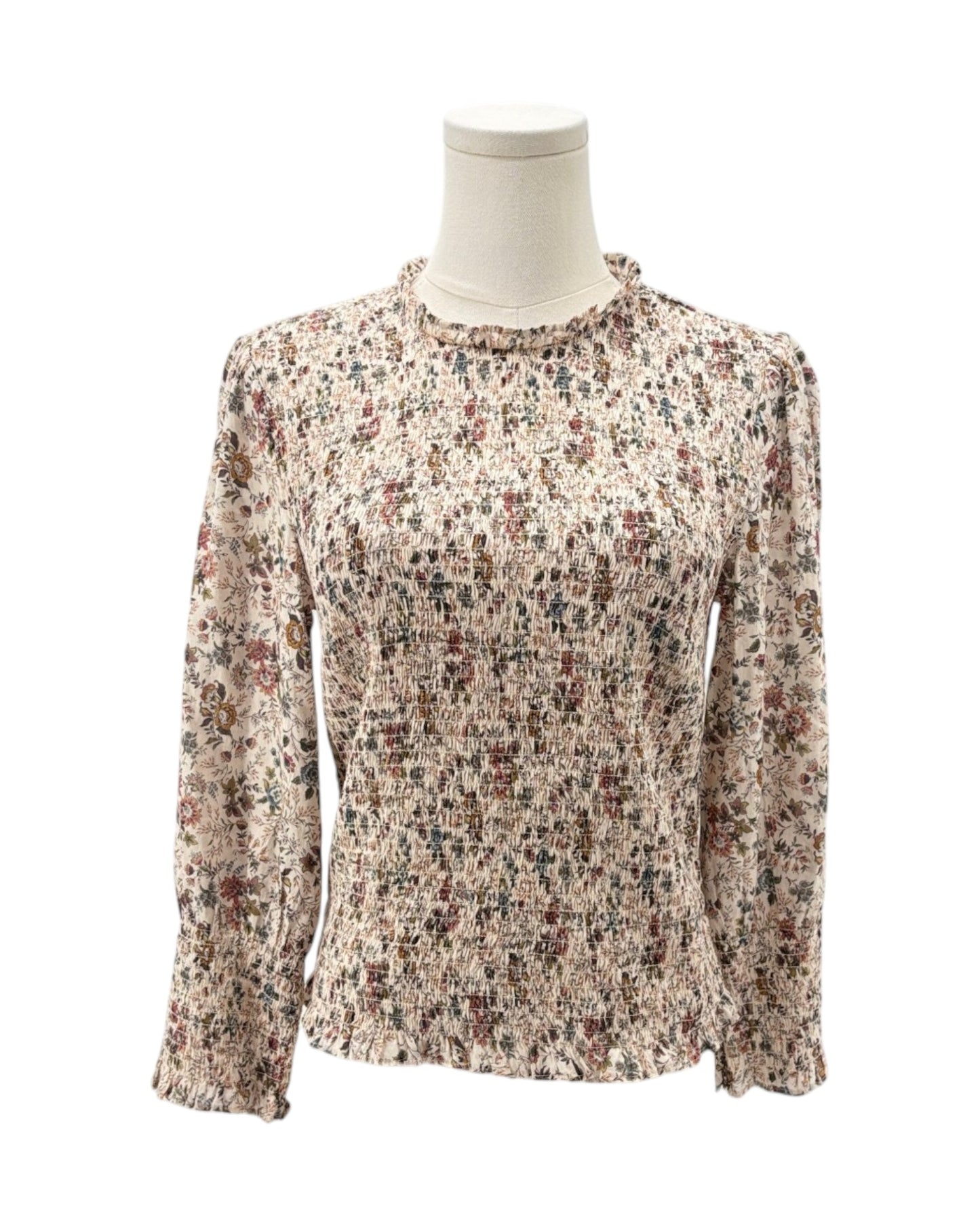 Floral patterned blouse on a mannequin against a white background